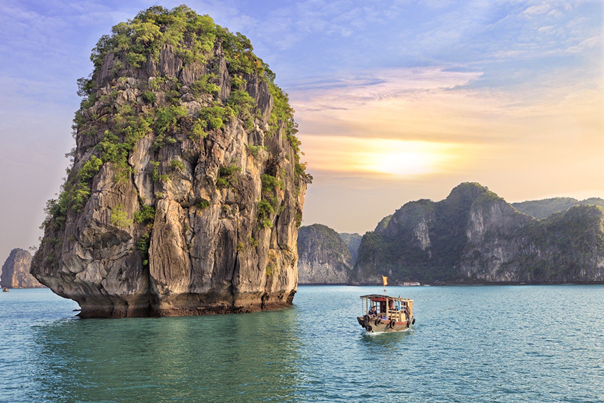 Watching the seascape sunset at Halong Bay is one of the top things to do in Vietnam
