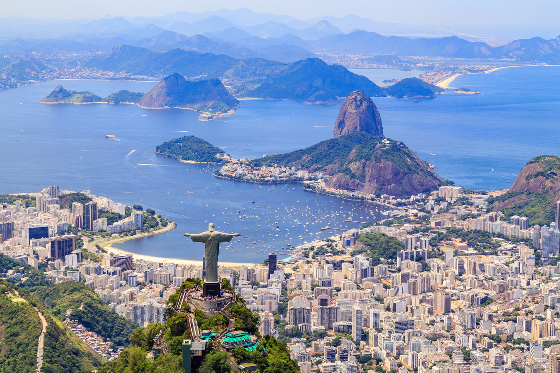 Christ, the Redeemer looks over Rio de Janeiro in Brazil Rio de Janeiro with its blue sea, small islands and the coastline, best time to visit Brazil.