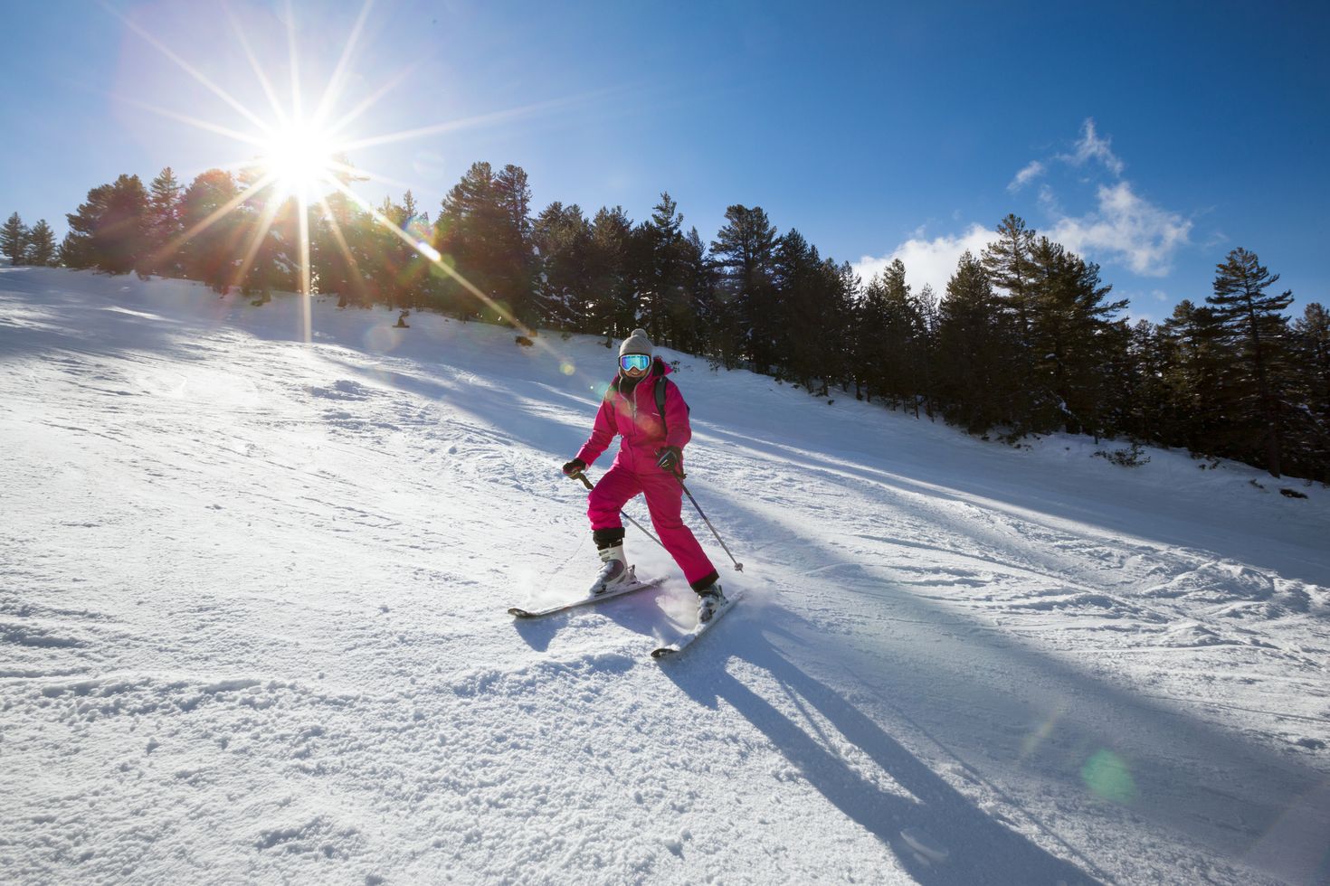 A lady skies on the snowy slopes of Bulgaria.