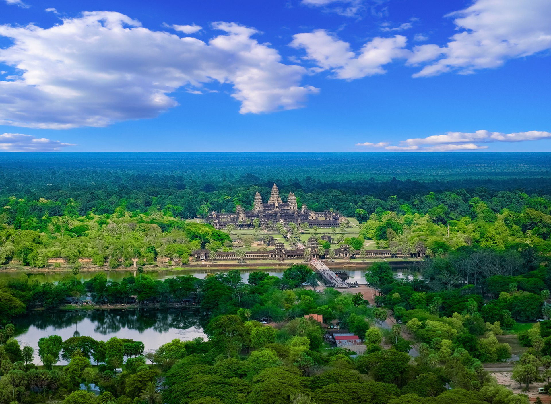 Aerial view of Angkor Wat Temple surrounded by green forests. The best time to visit Cambodia is from October to May.