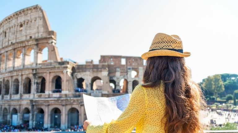 A tourist visiting the Colosseum on the best time to visit Italy.