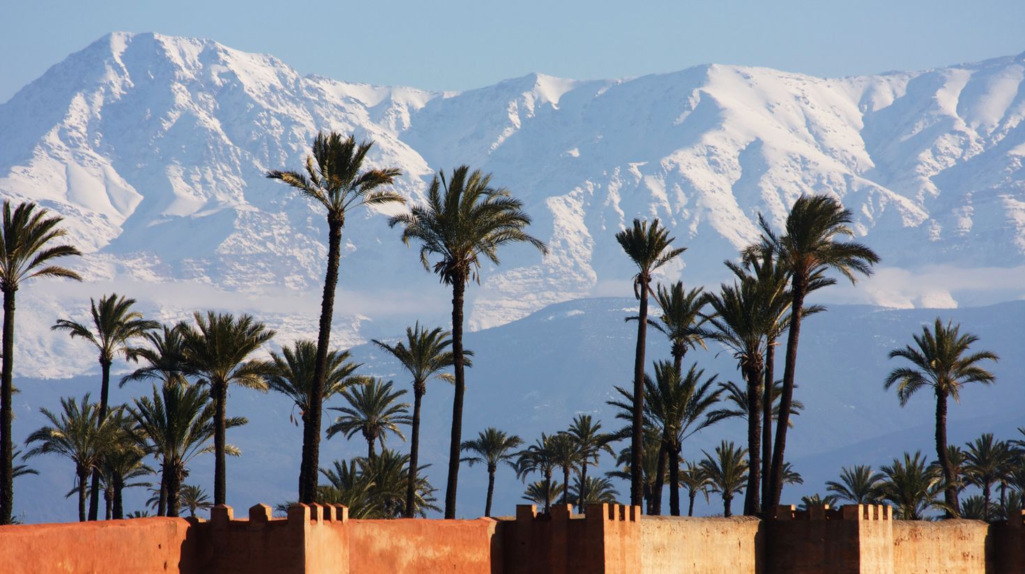 Marrakech in winter with snowy mountains in the distance.