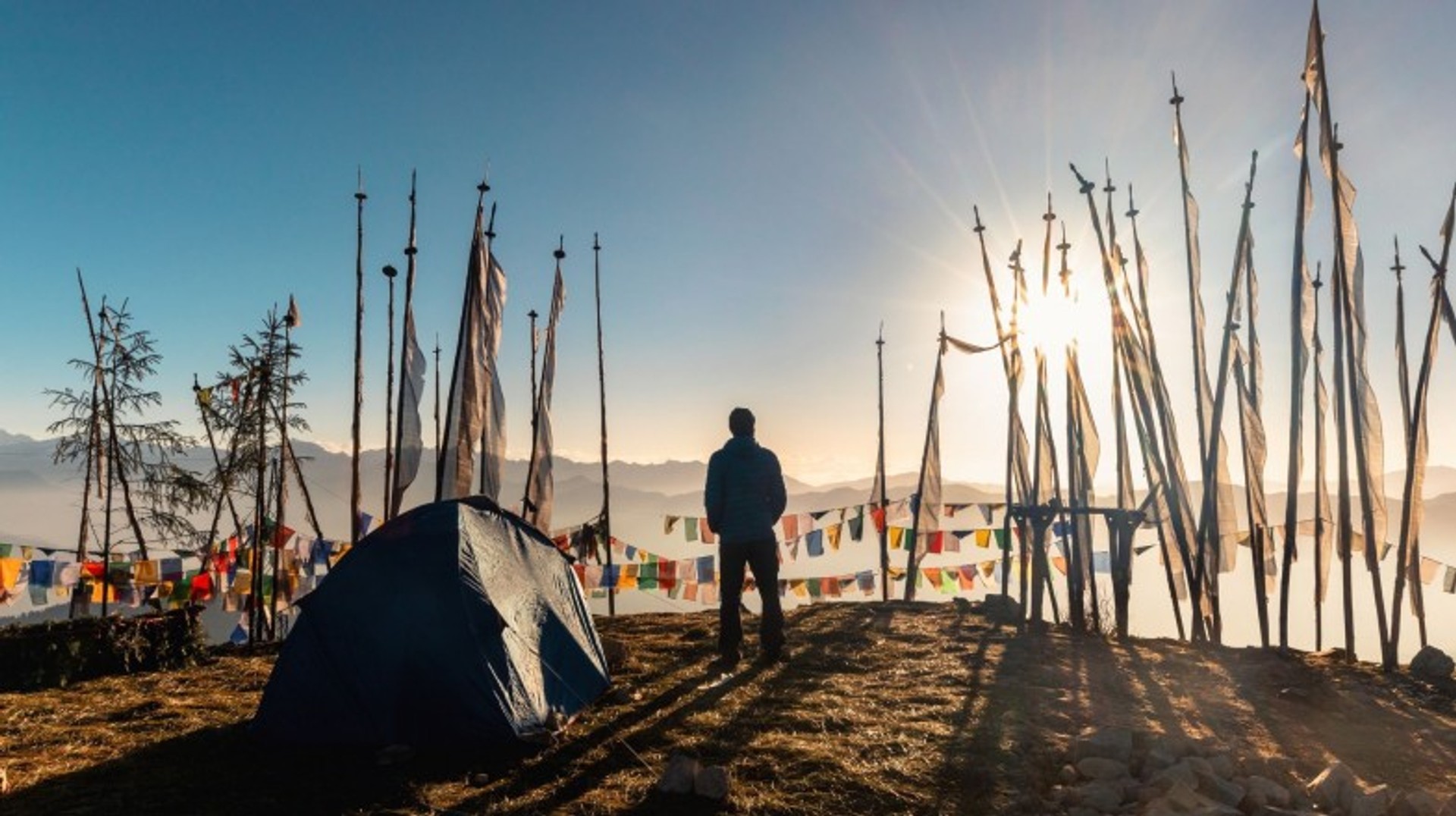 Catch a breathtaking sunrise at Chele La Pass and soak in the panoramic Himalayan views during your 2 weeks in Bhutan trip. A man enjoying the sunrise in Chele la during his 2 weeks in Bhutan.