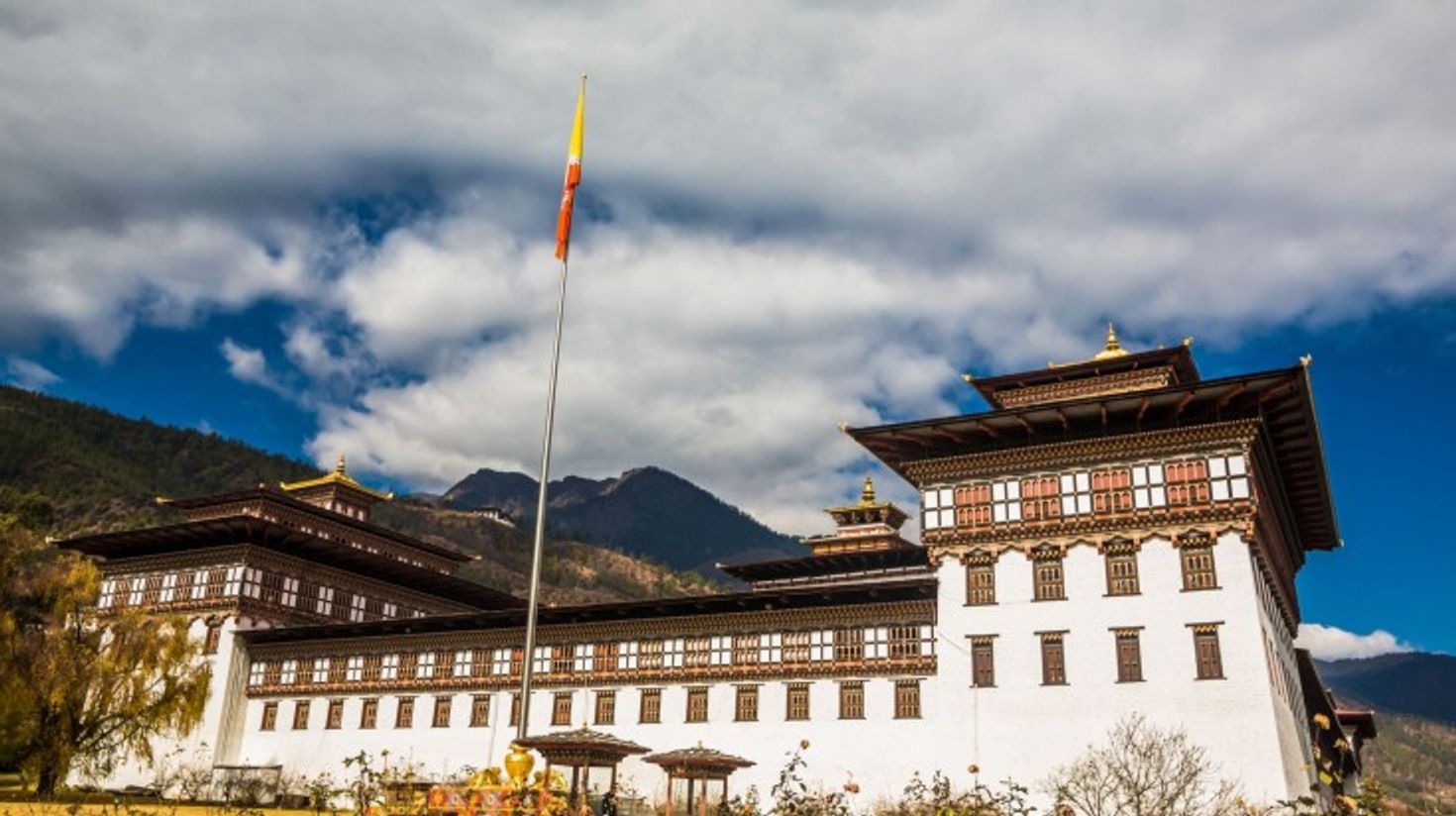 The front view of Tashichho Dzong on a cloudy day in Bhutan.