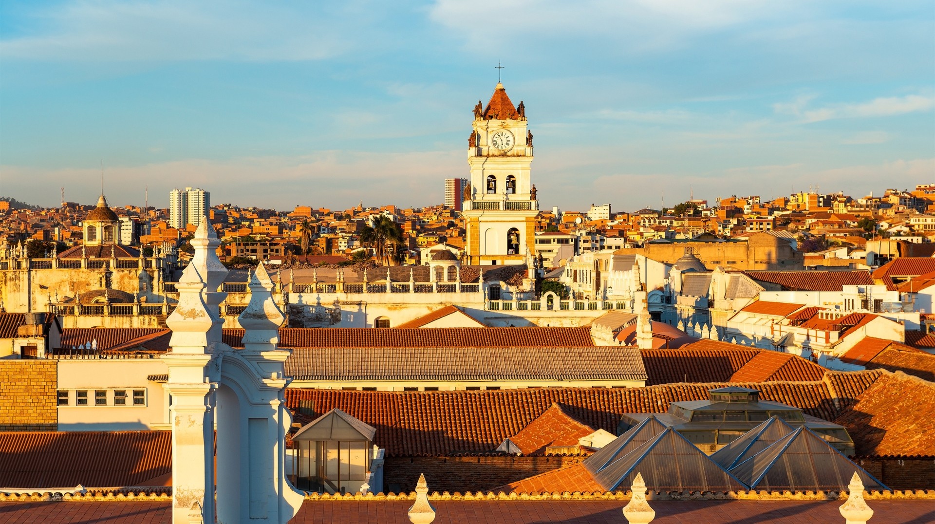 The cityscape of Sucre at sunset with its colonial-style rooftops and Cathedral tower in Bolivia in November.