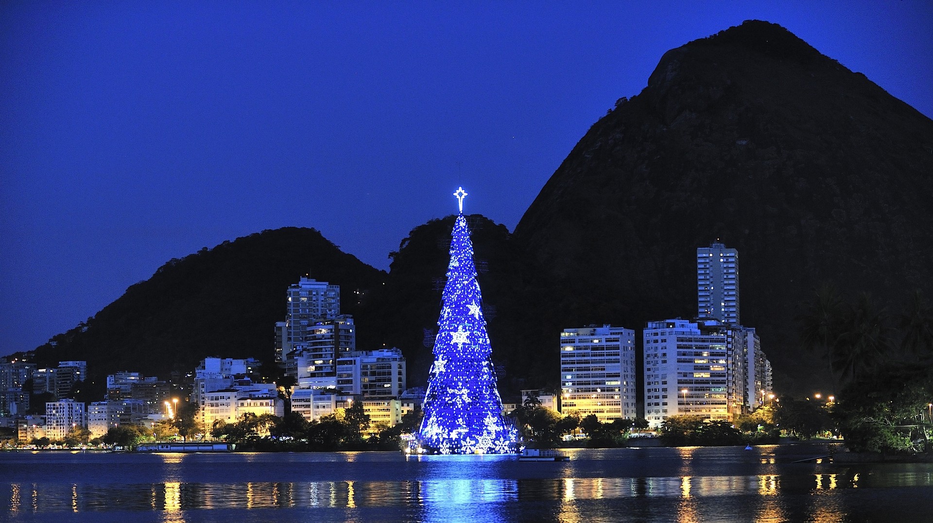 An impressive metallic structure representing the Christmas tree is erect above the Rodrigo de Freitas Lagoon in Rio de Janeiro to mark the holiday season. Christmas Tree on the water of Lagoon, Brazil in December
