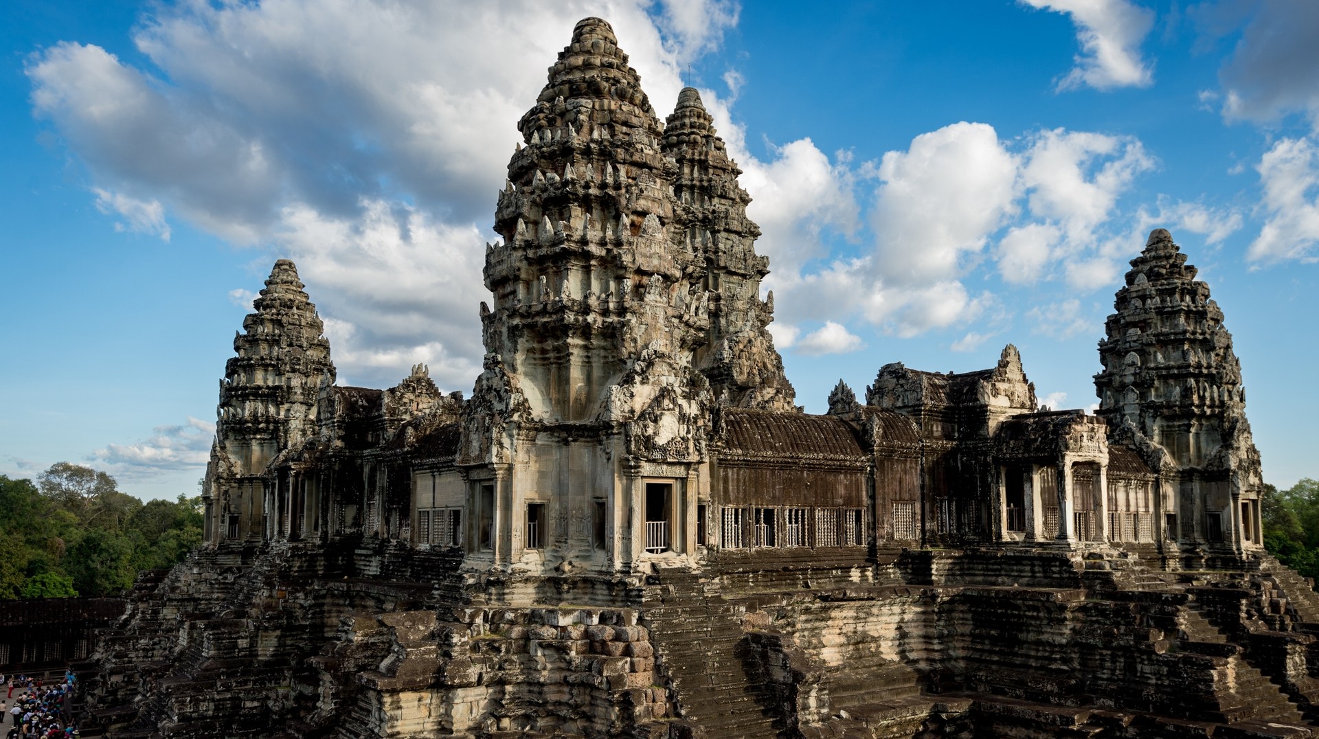 Find the ancient remains of the Khmer Empire at Angkor Wat. A view of Angkor Wat on a cloudy day you can see in Cambodia in April.