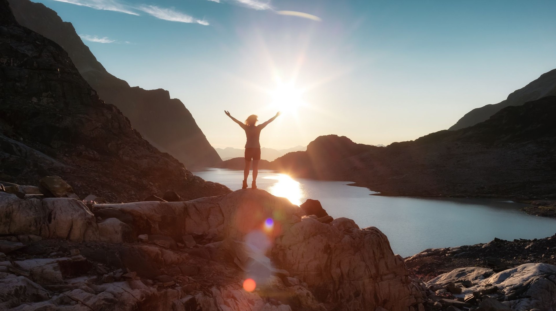 A woman with open arms in the Rocky Mountains during her 5 days in Canada.