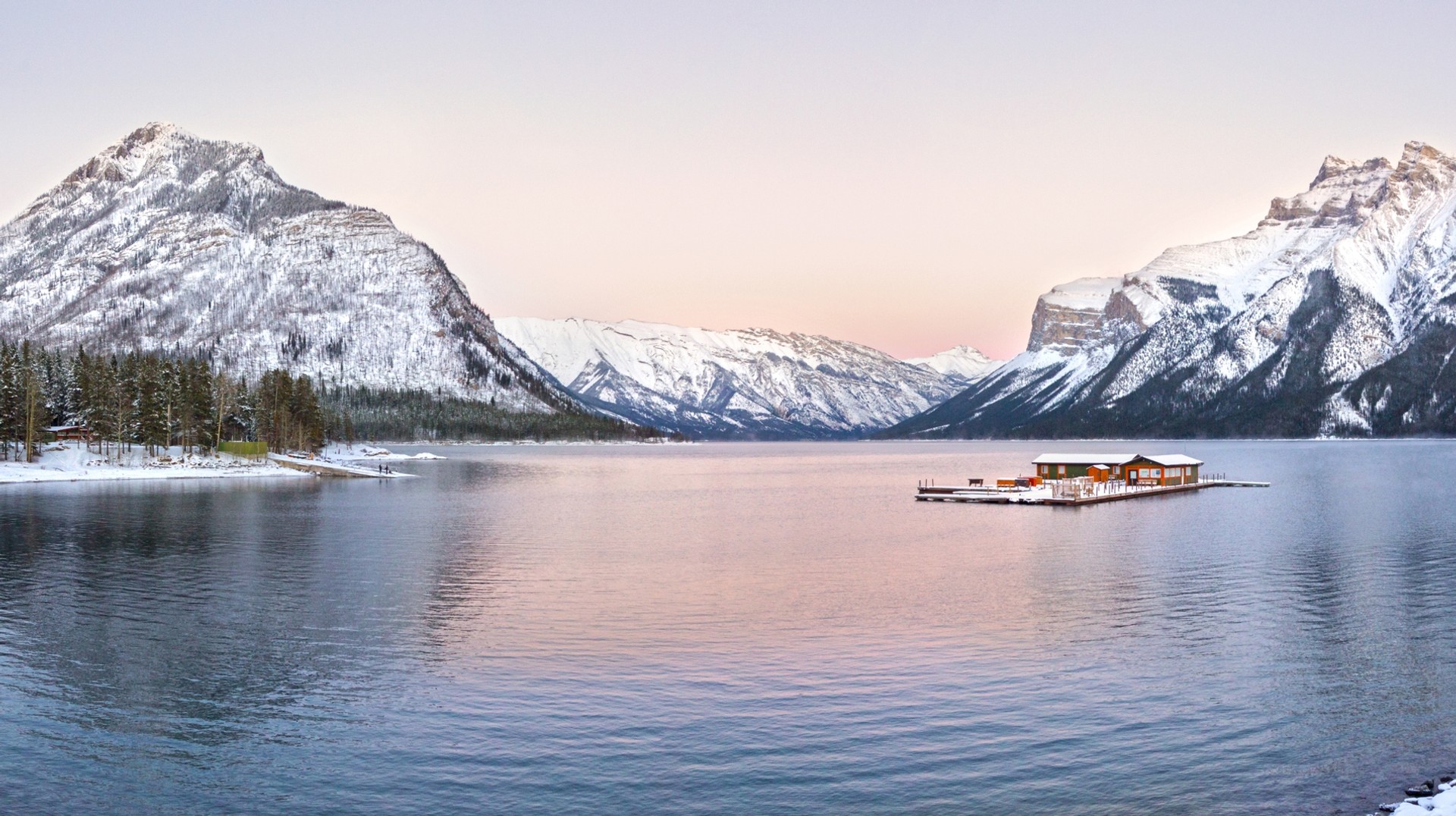November in Canada brings winter, snow and the start of ski season. Panoramic view of snowcapped rocky mountains at Lake Minnewanka in Canada.