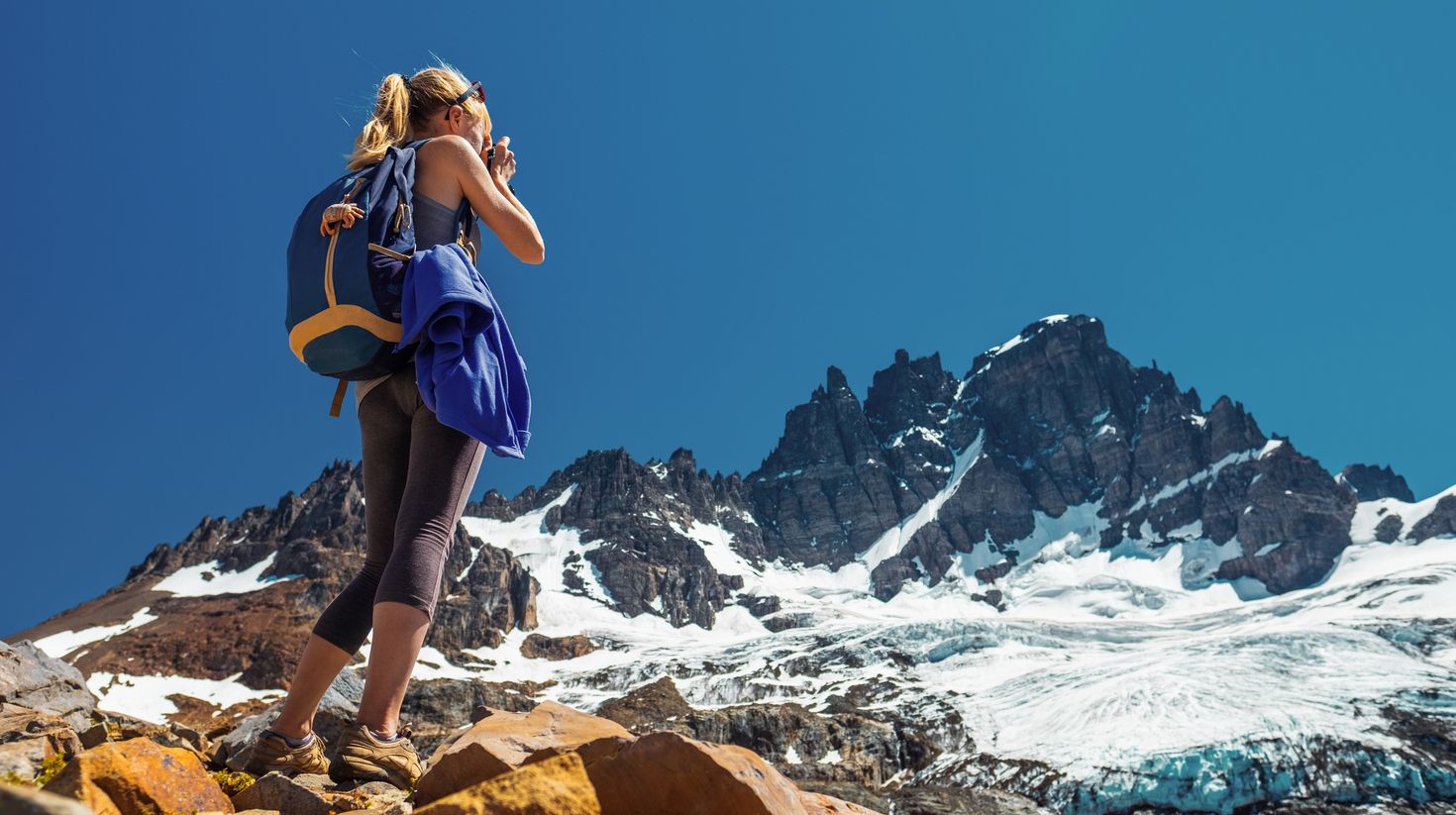Hiker takes picture of the mountain with glacier. Cerro Castillo Mountain,
