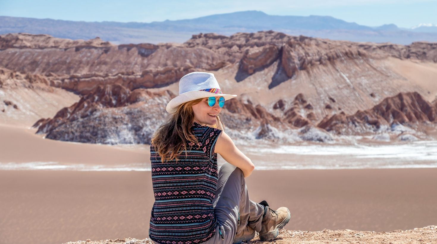 A tourist posing in the Atacama Desert in Chile.