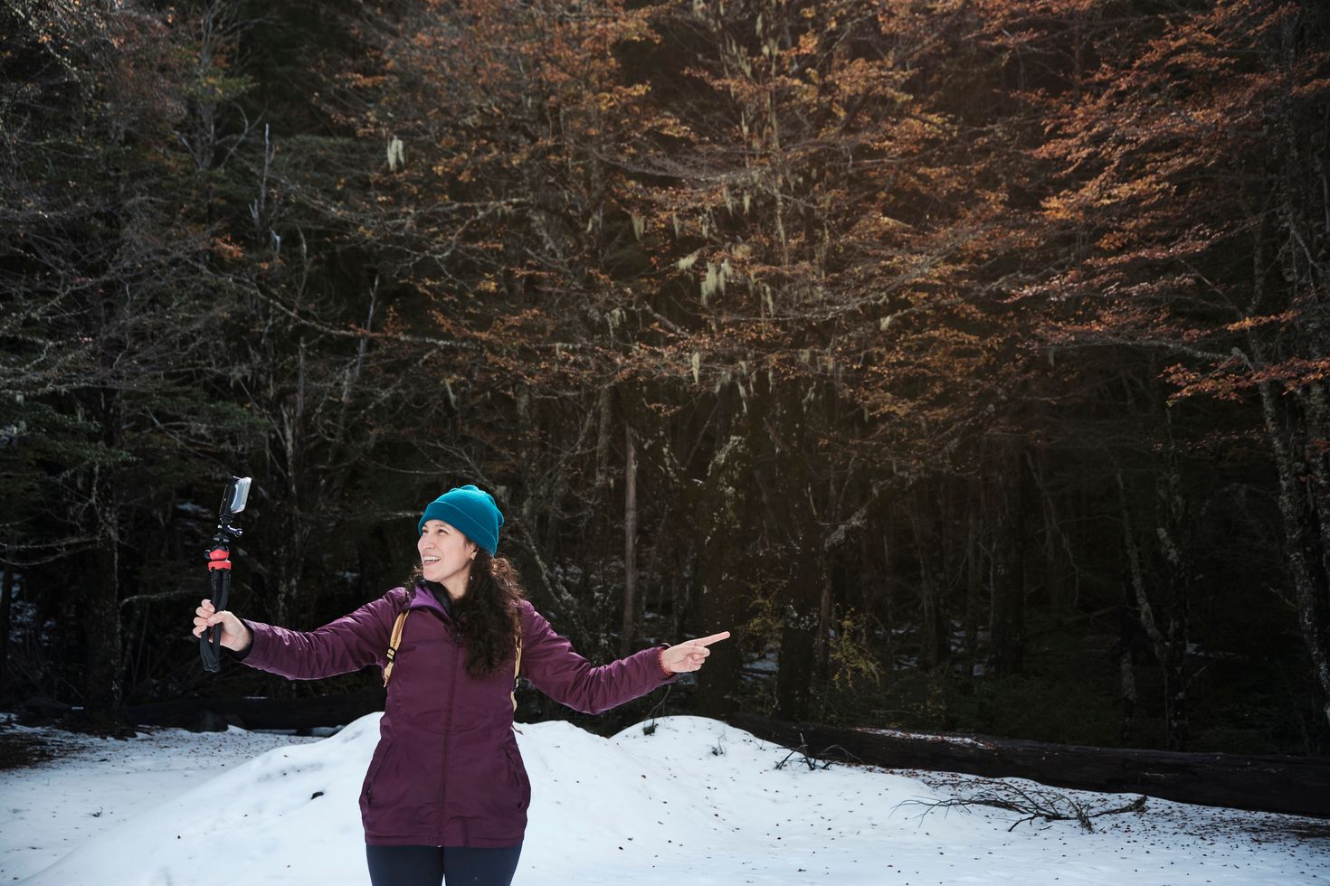 A woman filming herself in the native forest of Chile.