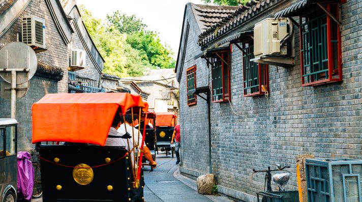 Tourists exploring the Beijing Hutong in traditional rickshaws
