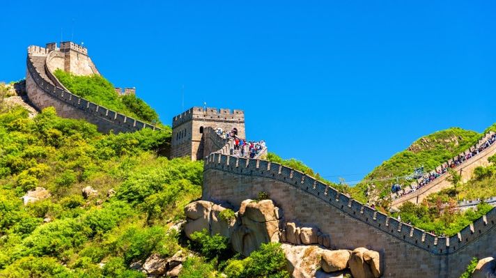 Tourists walking the Great Wall of China on a sunny day