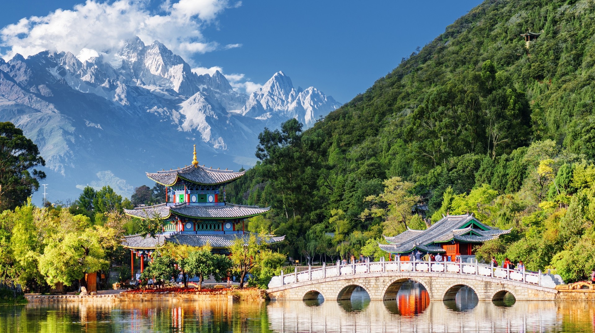 July is the hottest month in China so head to cooler mountainous areas to escape the heat. View of Jade Dragon Snow Mountain and Black Dragon Pool in China in July.