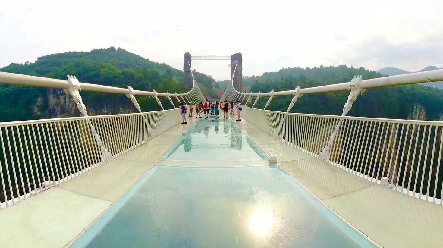 Tourists walking on world's longest glass bridge at Zhangjiajie.