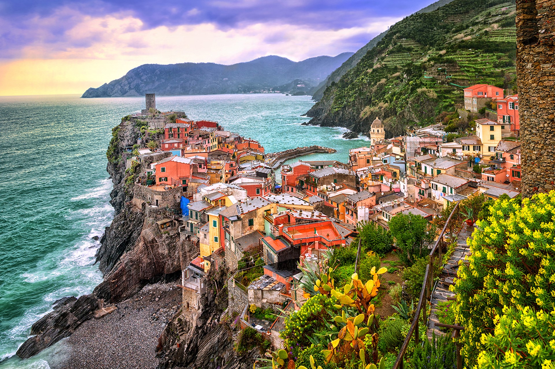 The colorful village of Vernazza and ocean coast in Cinque Terre in Italy on a clear day.
