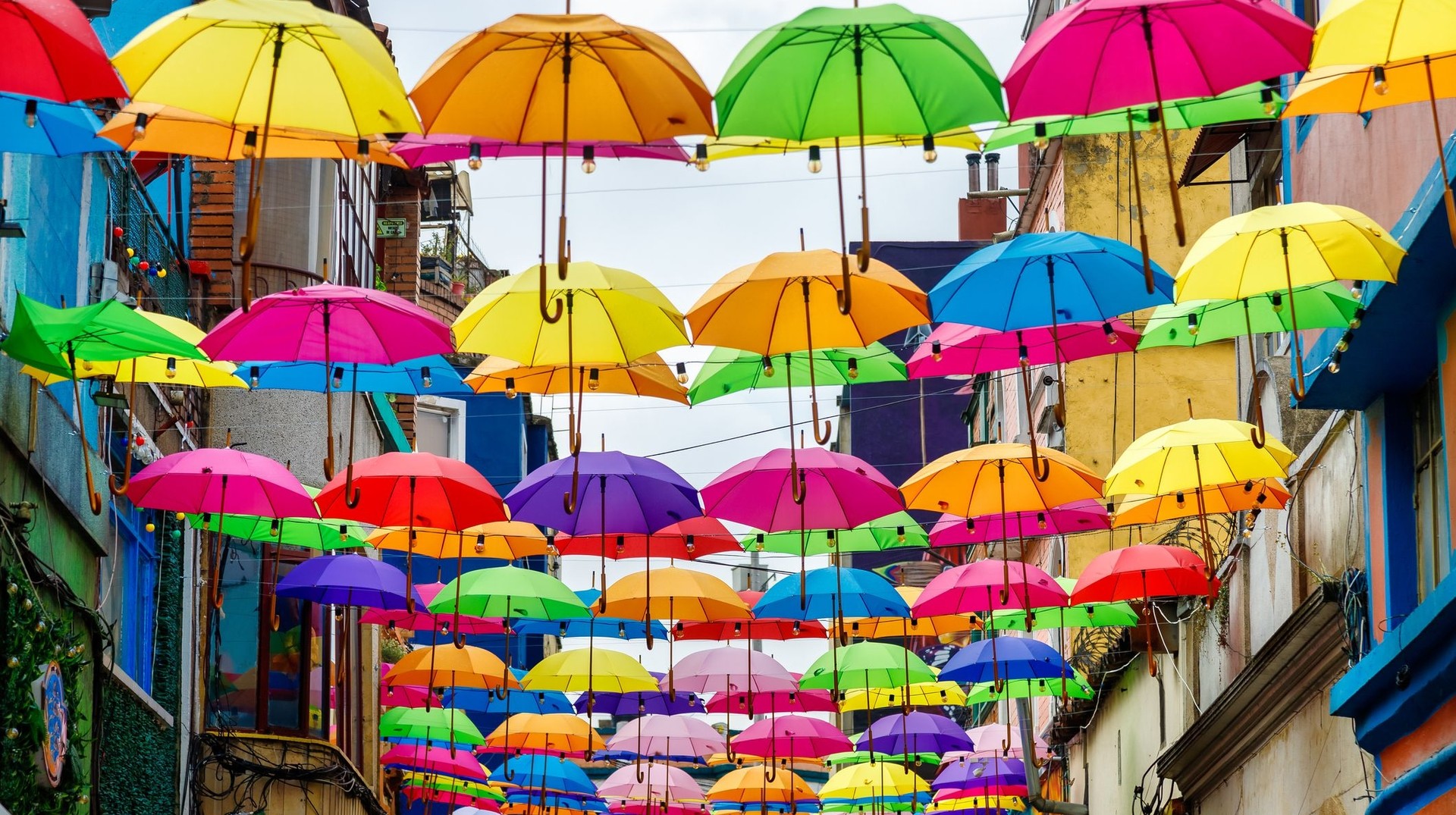 The colorful streets of Bogota make it a top travel destination on Colombia. See dozens of umbrellas on the streets during a 7-day trip of Colombia.