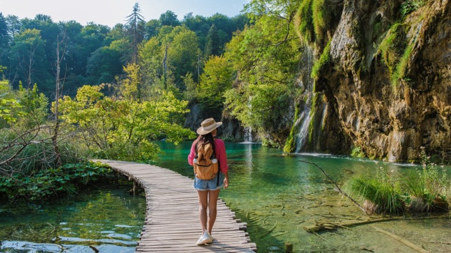 Embark on an unforgettable adventure during your 11 days in Croatia and explore the stunning beauty of Plitvice National Park. A tourist girl walking in Plitvice National Park during her 11 days in Croatia.