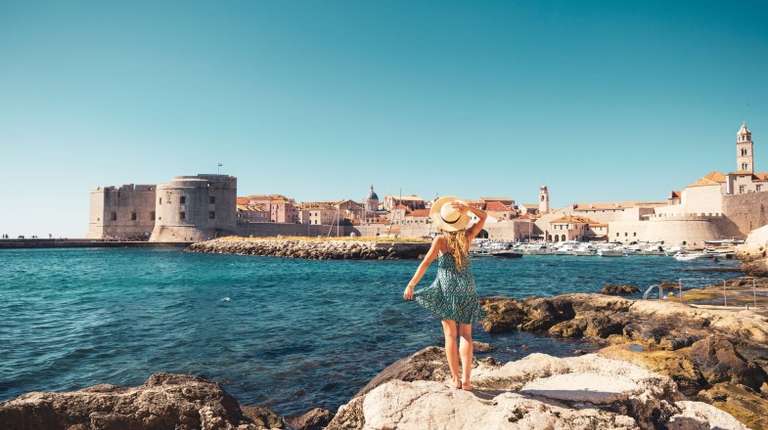 A girl enjoying the view of Dubrovnik on her 12 days in Croatia trip.