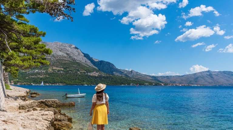 A tourist girl admiring the beauty of Korcula during her 8 days in Croatia trip.