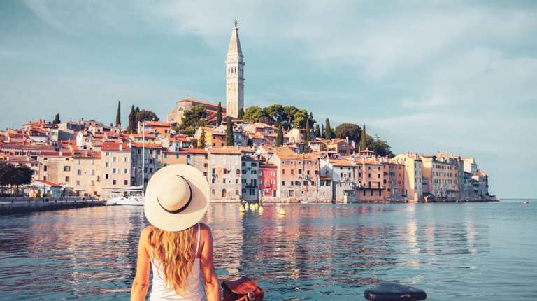 A tourist girl admiring the beauty of Dubrovnik during her 9 days in Croatia.