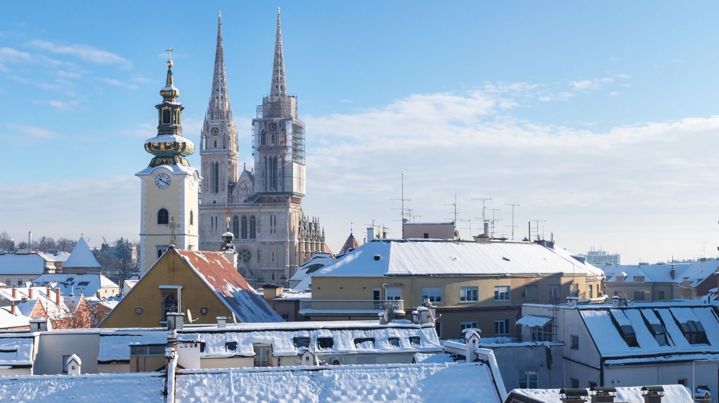 View of houses and Cathedral in Zagreb with snowy roof, Croatia in February
