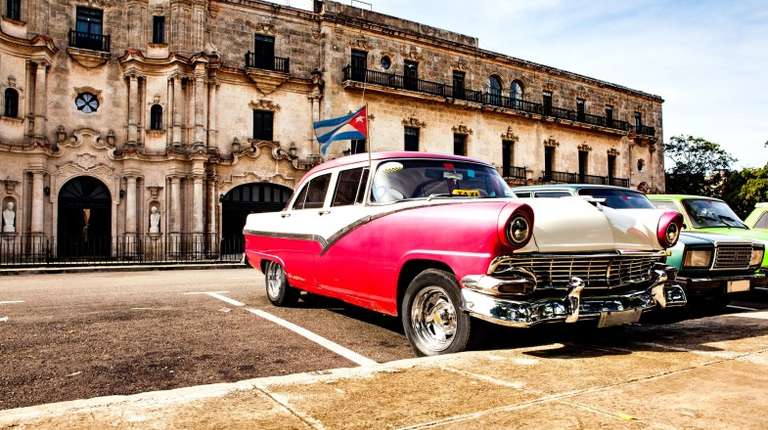 Old vintage cars parked outside in Old Havana in Cuba in February.