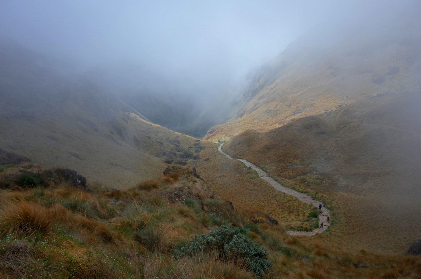 Trekkers walks a misty Inca Trail towards the Dead Woman's Pass