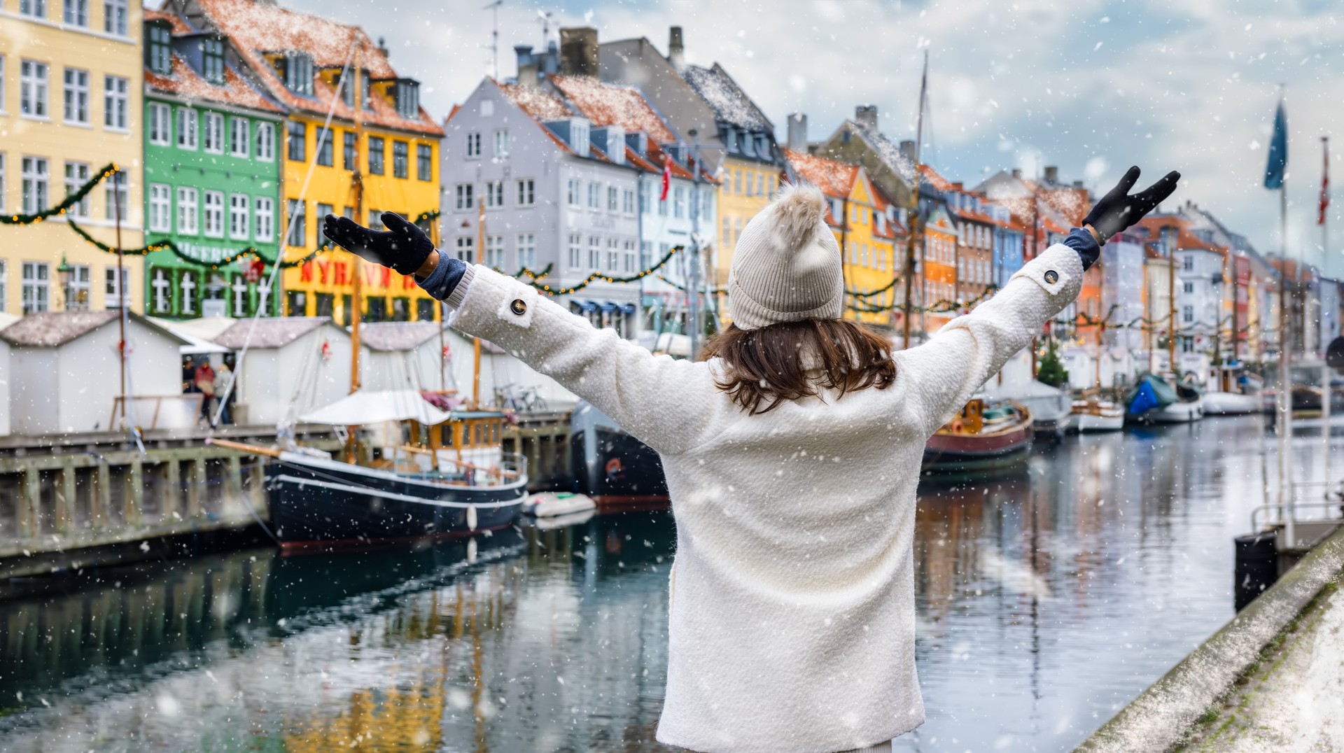 On your visit to Denmark in March, be sure to enjoy strolling through the otherwise crowded cities like Copenhagen for a tranquil experience. Woman enjoying in Copenhagen on her trip to Denmark in January.