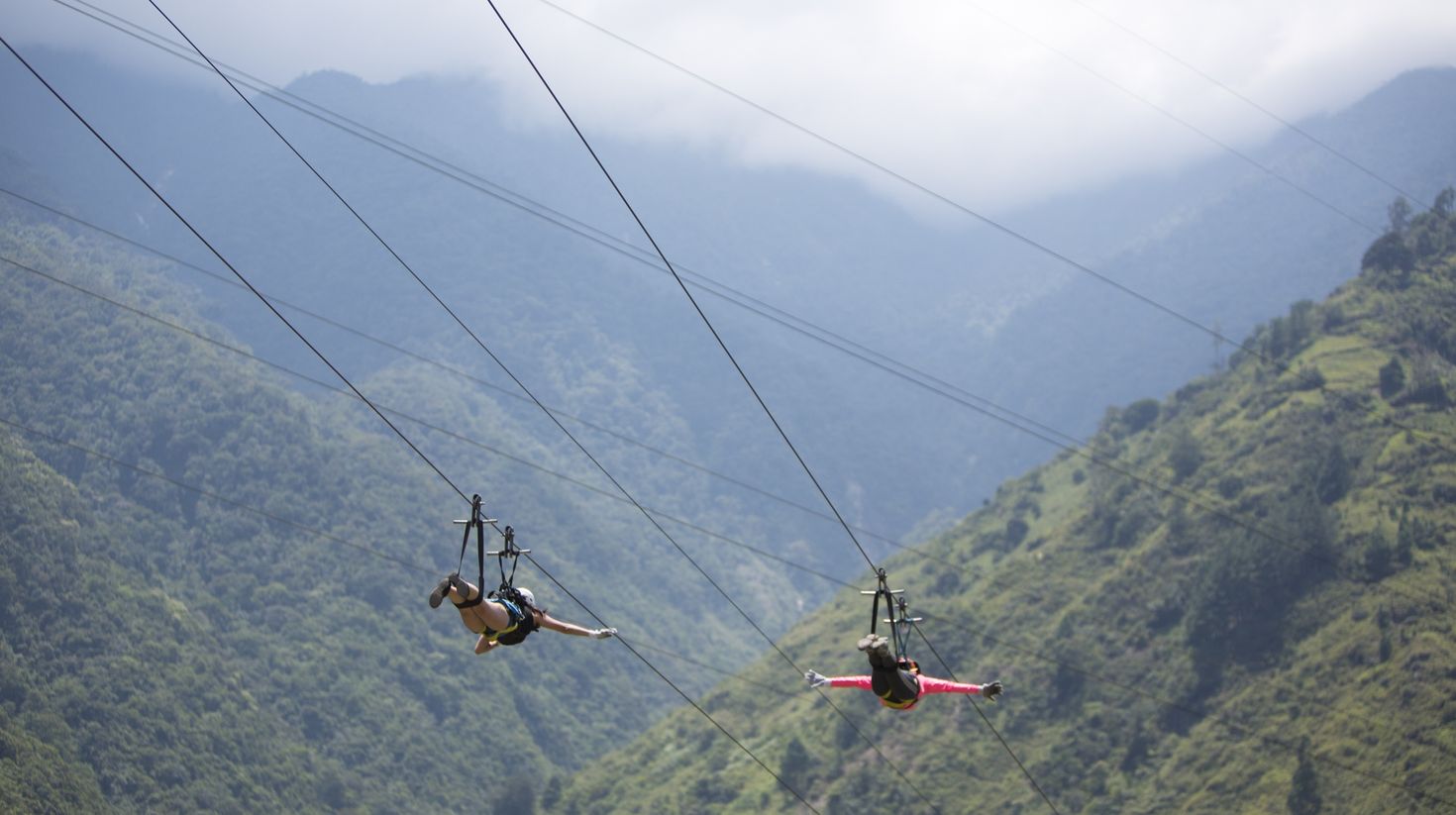 Zip through forest canopies in Banos.