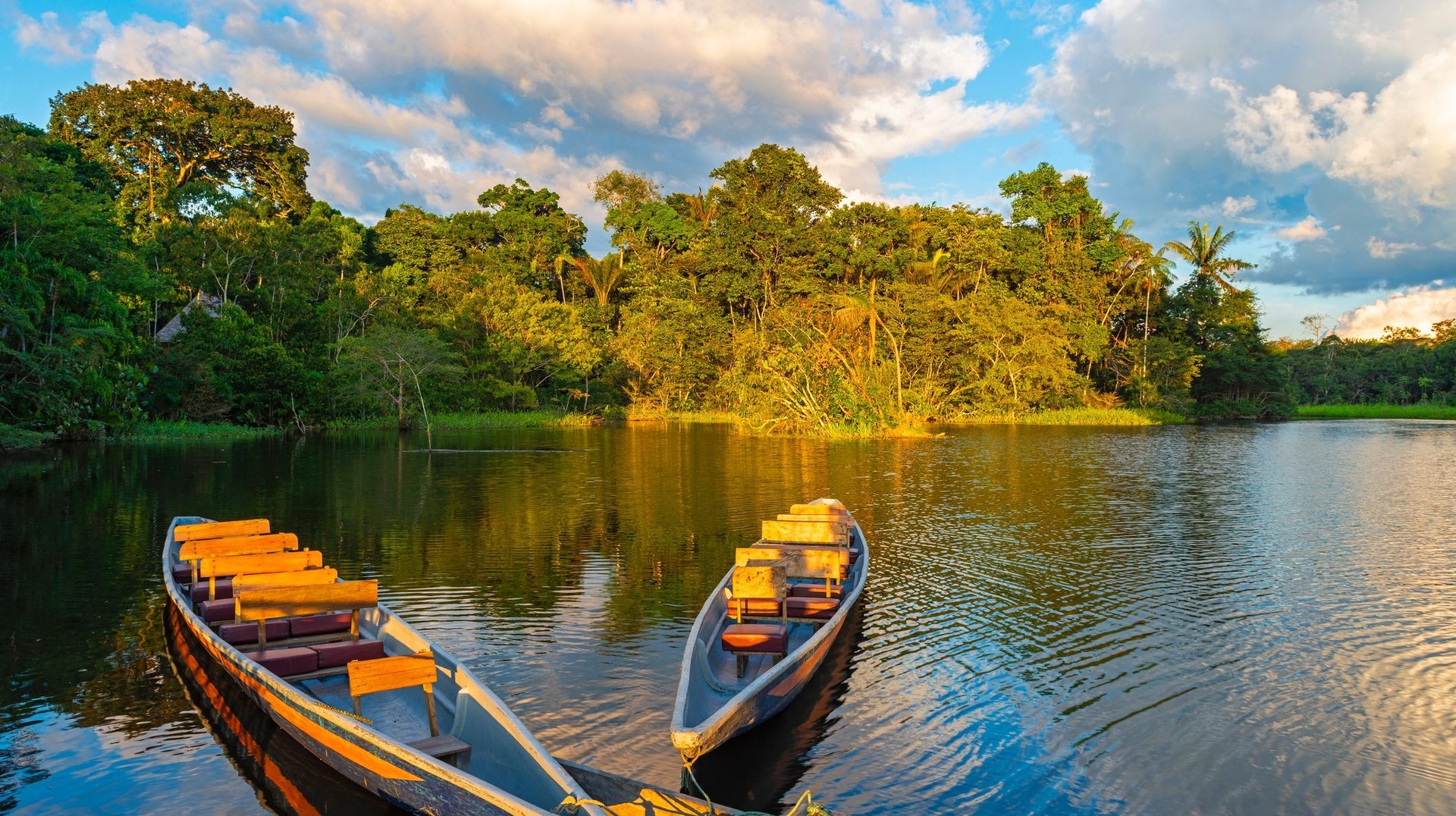 Canoes at sunset in Amazon rainforest during your one week in Ecuador.