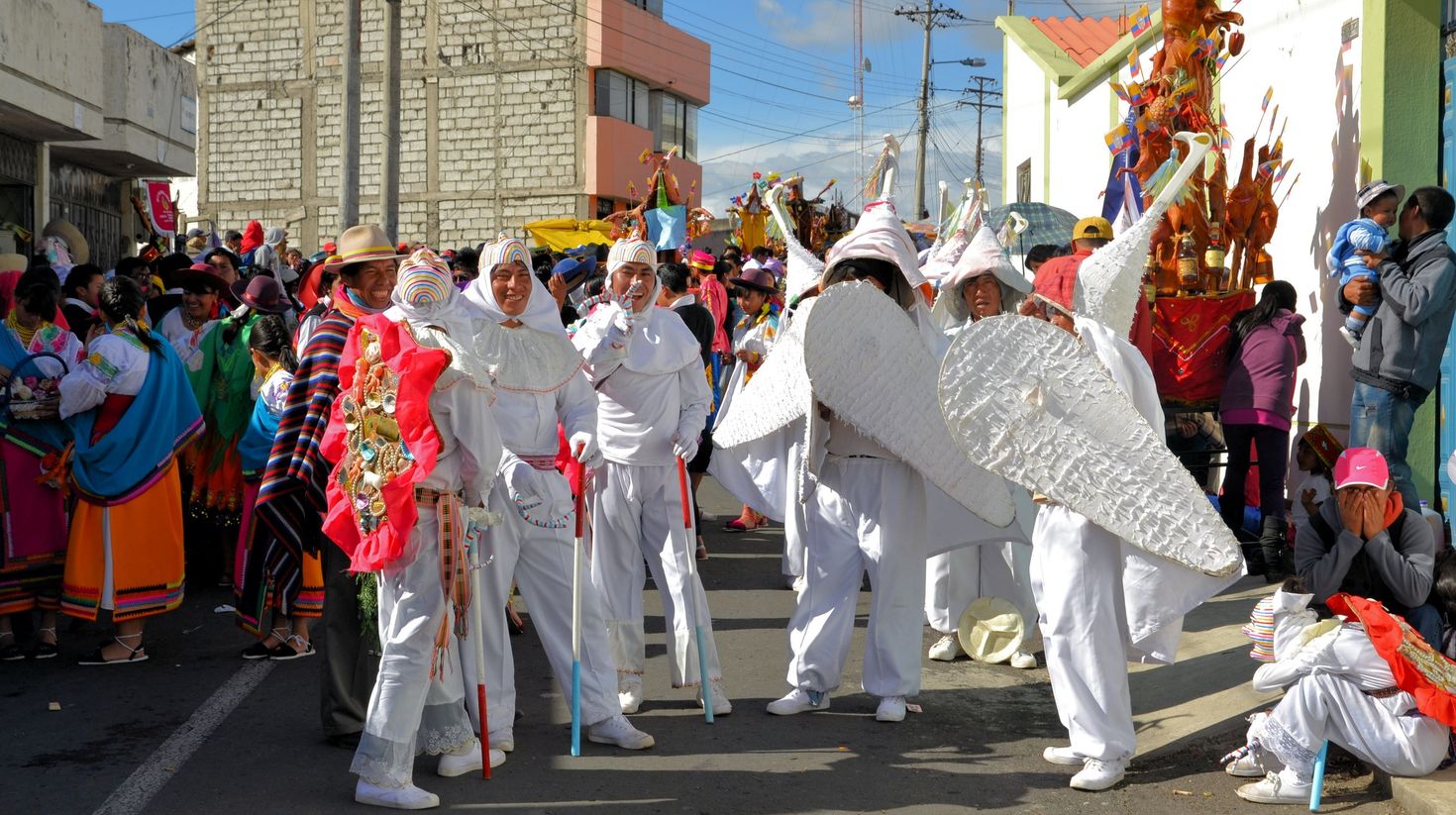 Locals wear colorful costumes and dance in Fiesta de Mama Negra.
