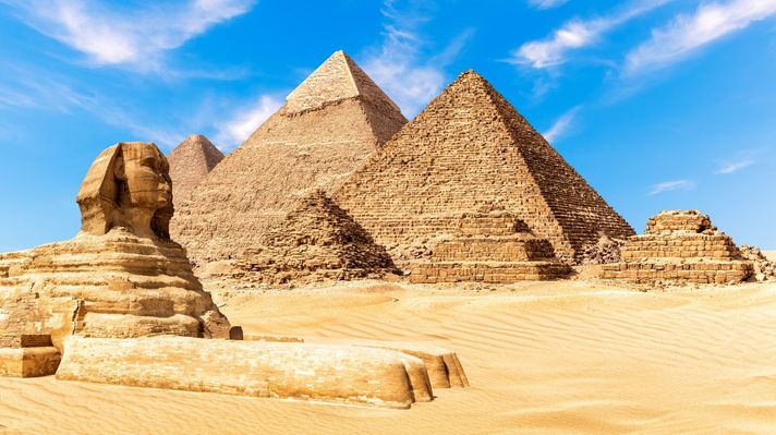 The Sphinx by the Pyramids of Giza in the desert of Egypt during a clear da