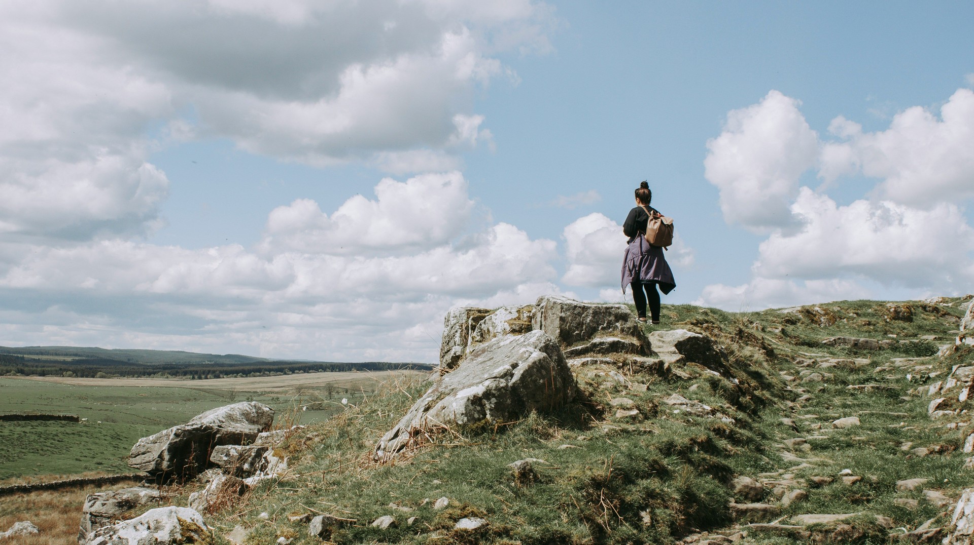 Girl hiking in Northumberland National Park during a stay of England in 4 days.