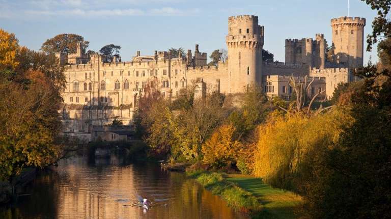 Man kayaks on the river that runs through Warwick Castle, England