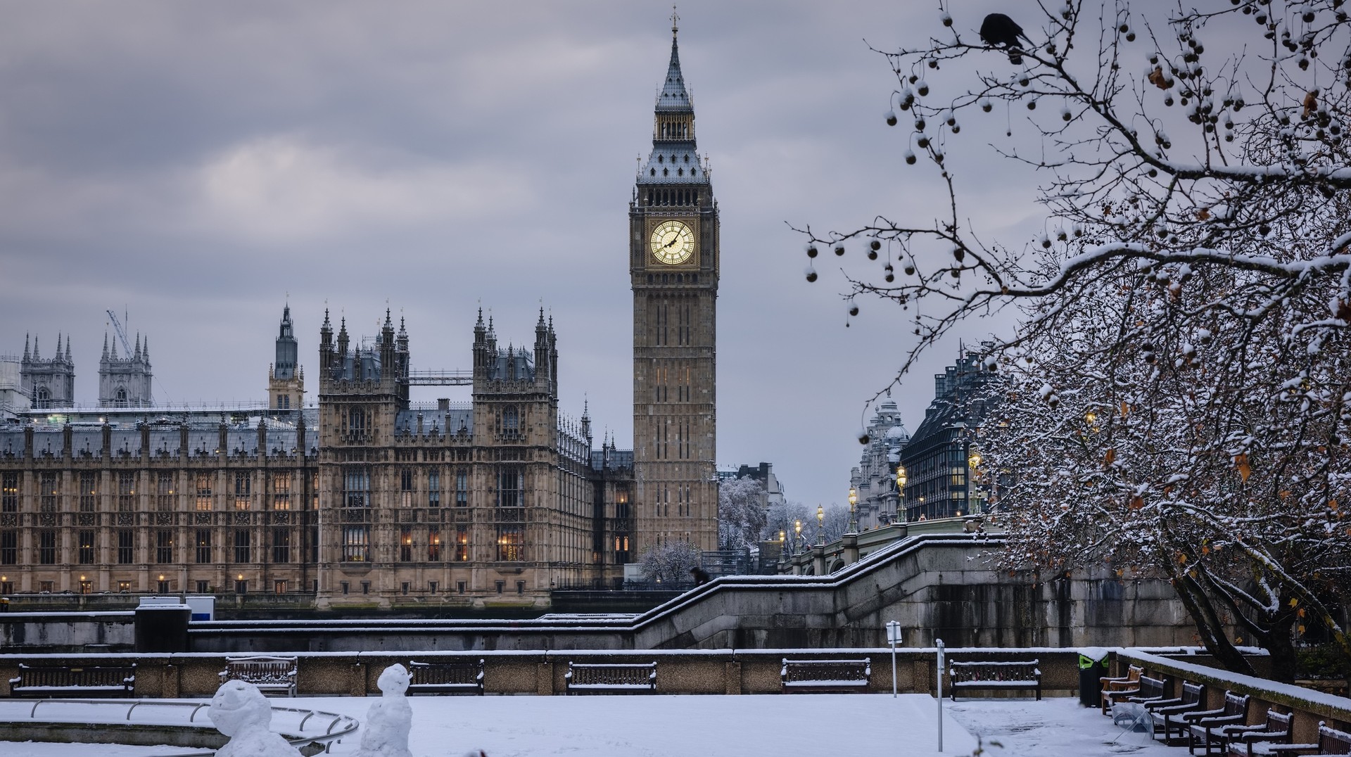 Experience England in February with crisp winter landscapes, occasional snow, cozy pubs, and a tranquil ambiance. Snowy Big Ben tower against winter sky in England in February.