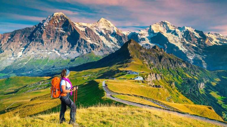 A hiker tourist admiring the view of Grindelwald during dusk on her 10 days in Europe trip.