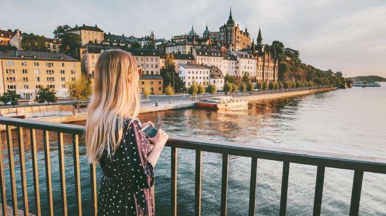 A girl admiring the view of Stockholm during dusk on her 9 days in Europe.