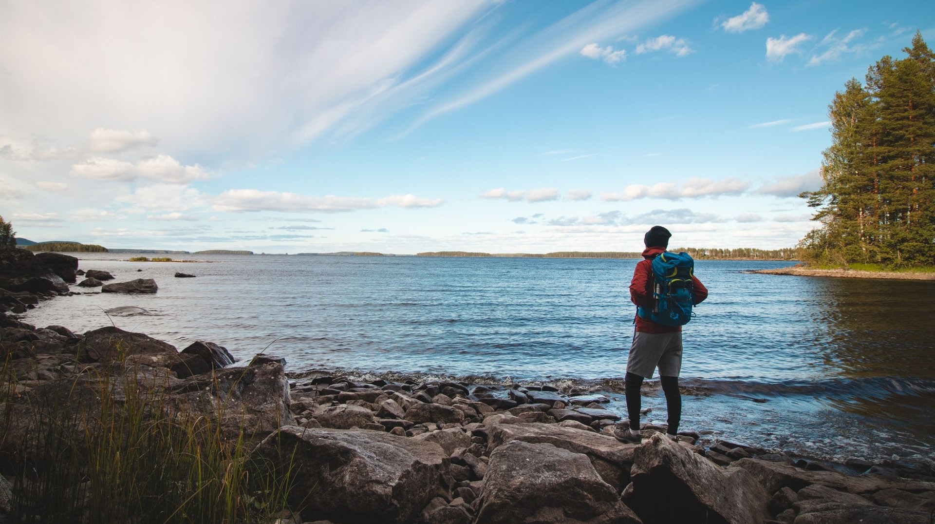 Immerse yourself in the natural beauty of Koli National Park during your 4 days in Finland and admire scenic trails, breathtaking views, and serene lakes. A man admiring the view of Koli National Park during his 4 days in Finland.