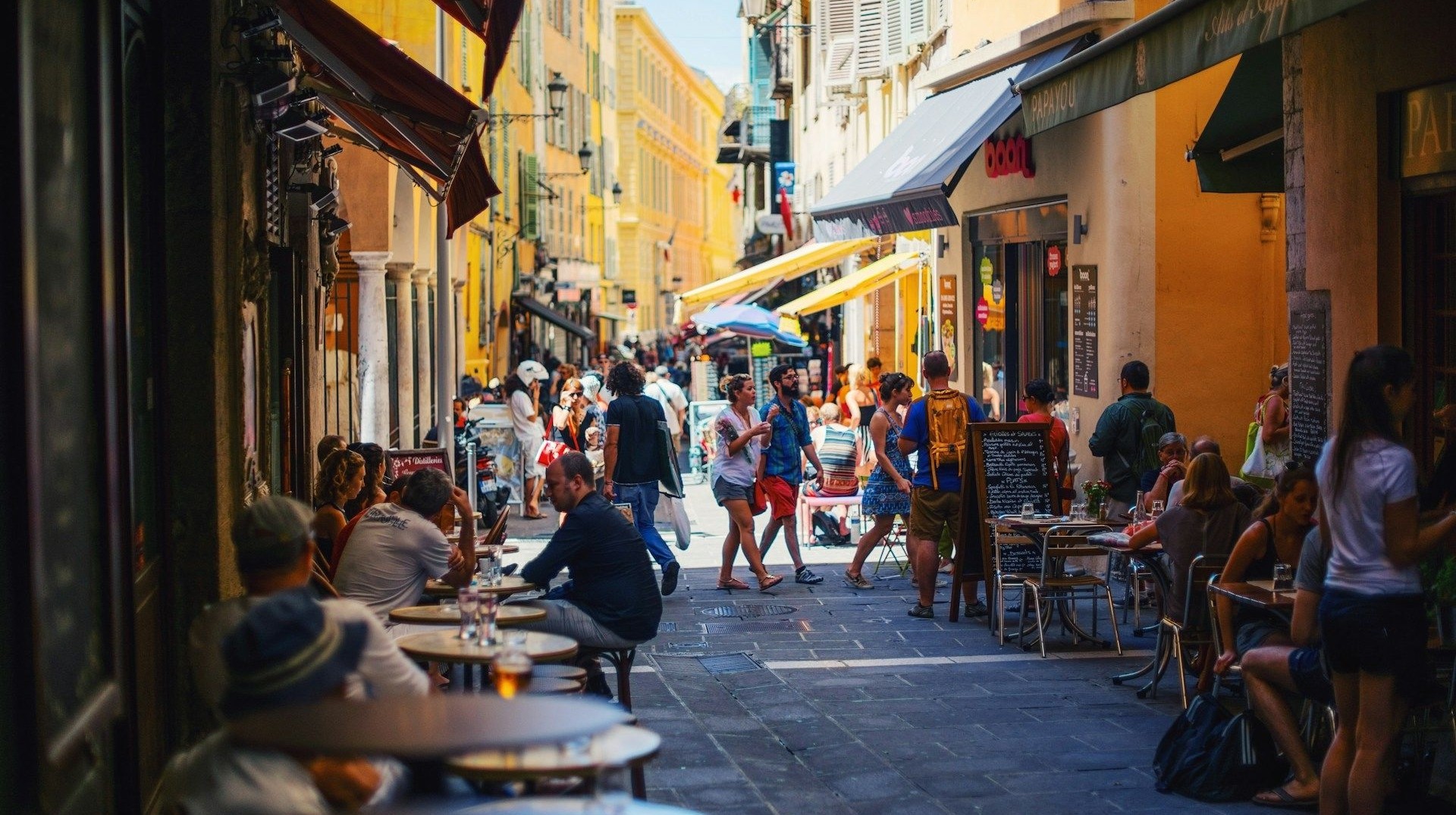 Take a walk down the vibrant streets in Nice filled with cool restaurants, cafes and bars. Locals & tourists in the colorful streets of Nice in France during 13 days