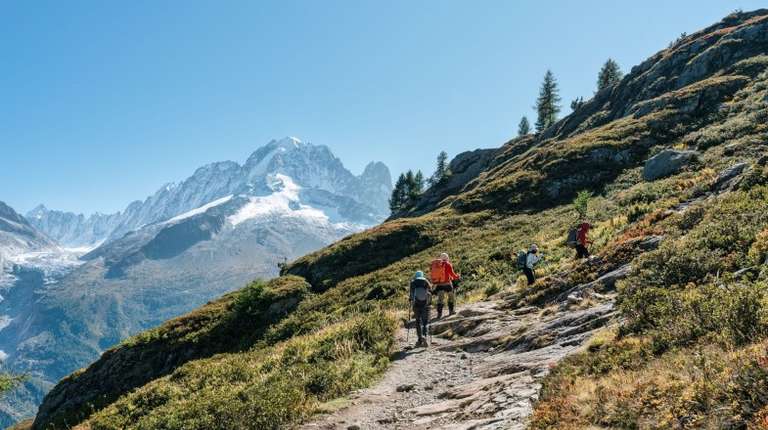 Travelers to France hiking in the French Alps on a sunny day