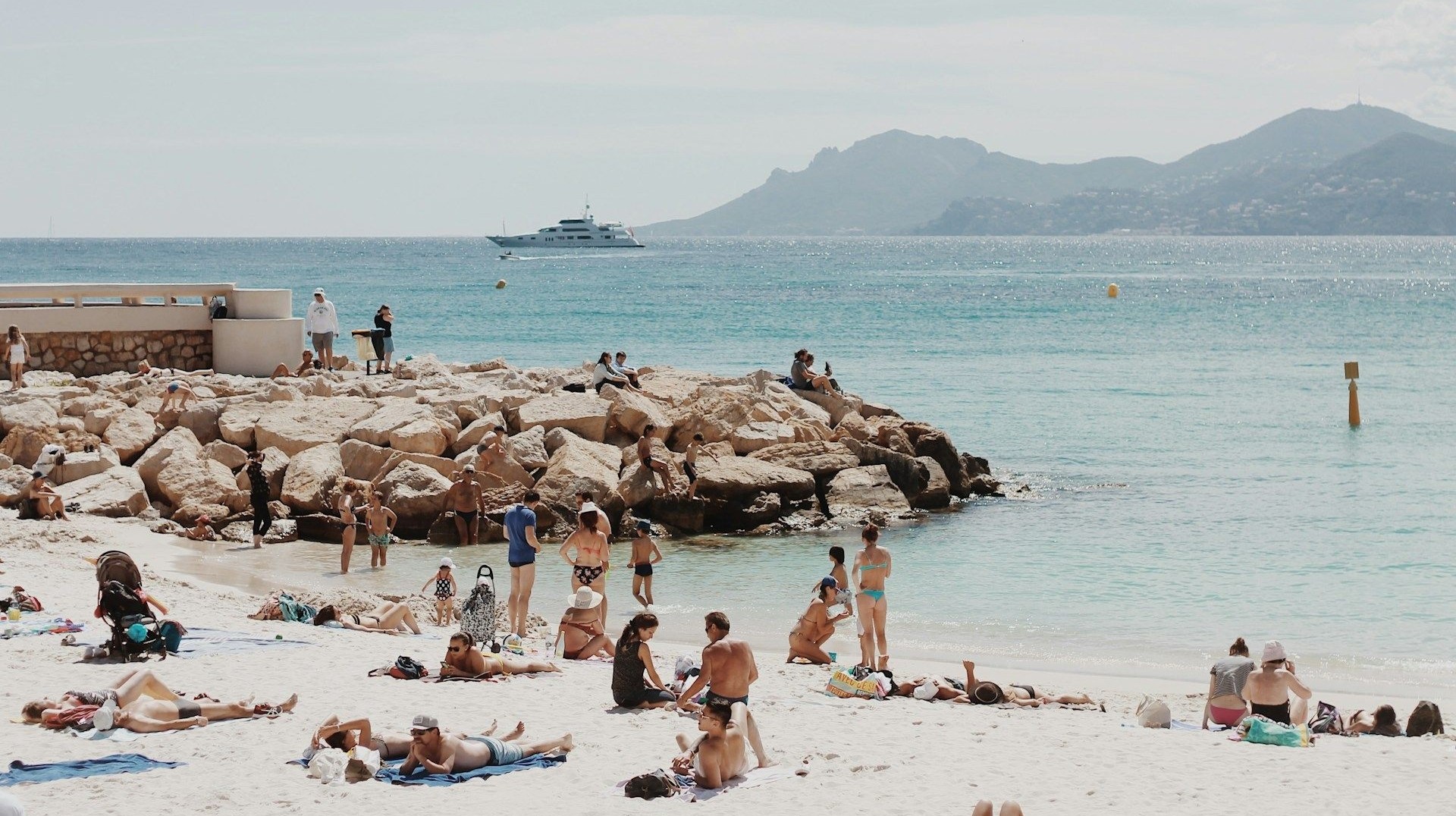 Cote d'Azur is blessed with some of the most beautiful beaches in the French Riviera. Beach in Cote d Azur filled with people on a vacation in France
