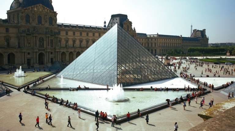 People enjoying Louvre pyramid and its fountain in France during 8-day stay