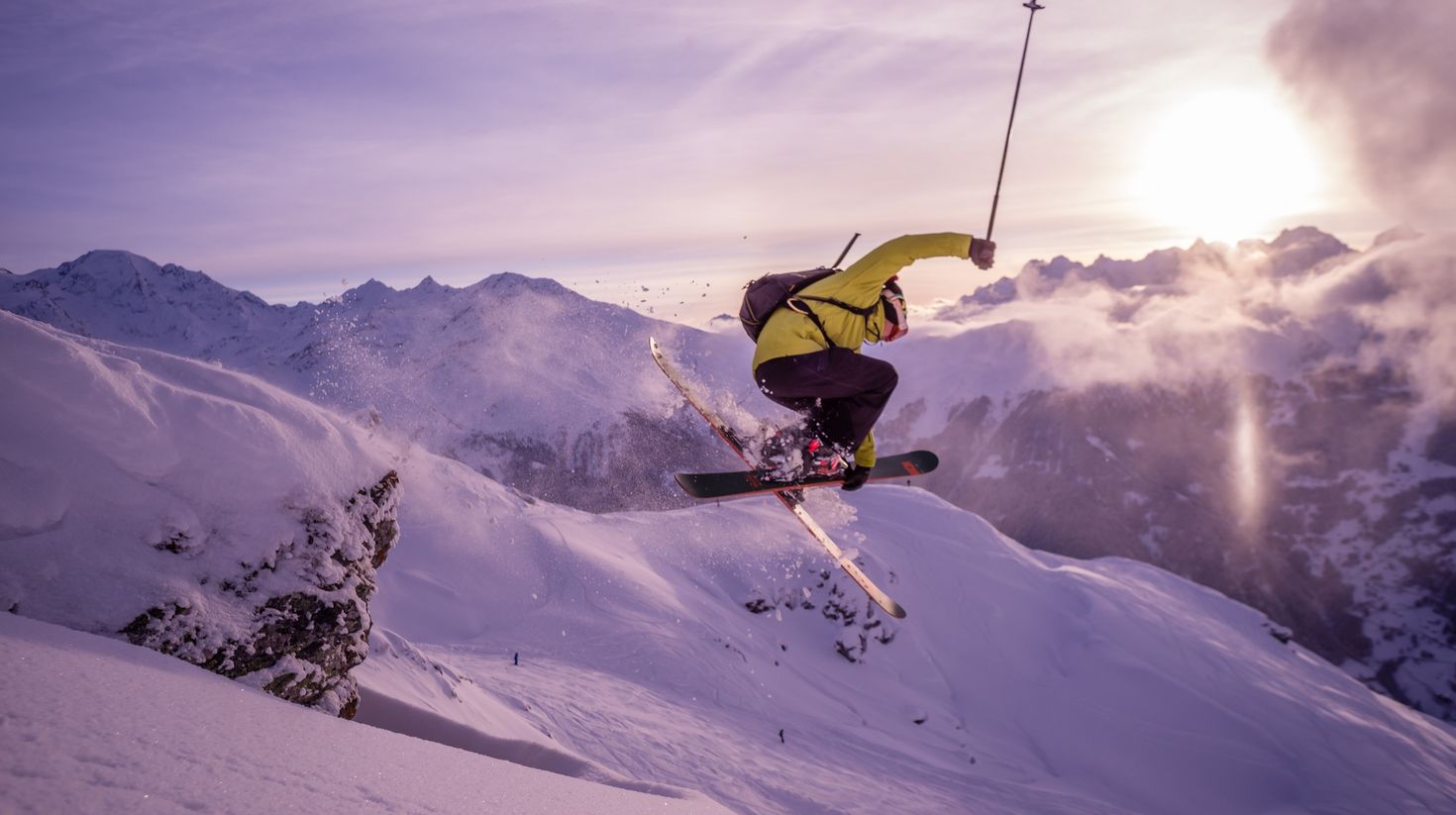 A skier flies through the air on the ski slopes in the Chamonix range