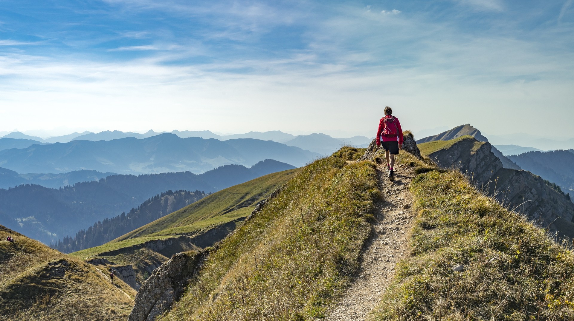 You will love to hike in the lovely weather while you travel to Germany in July. A hiker walking in Bavaria in Germany in July.