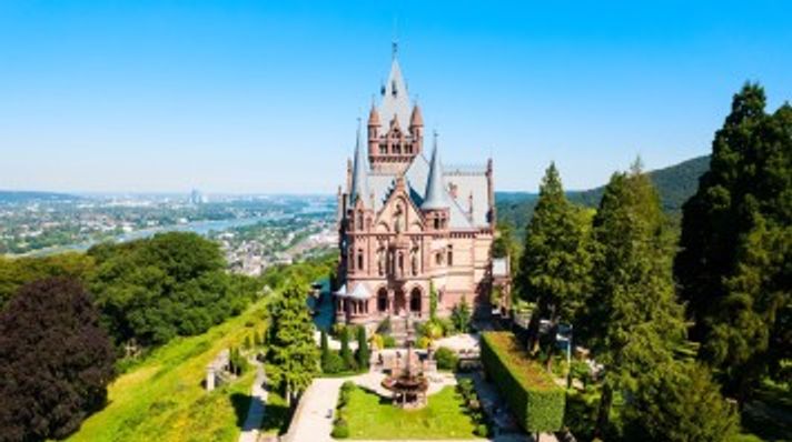 Aerial view of Schloss Drachenburg Castle on a bright sunny day.