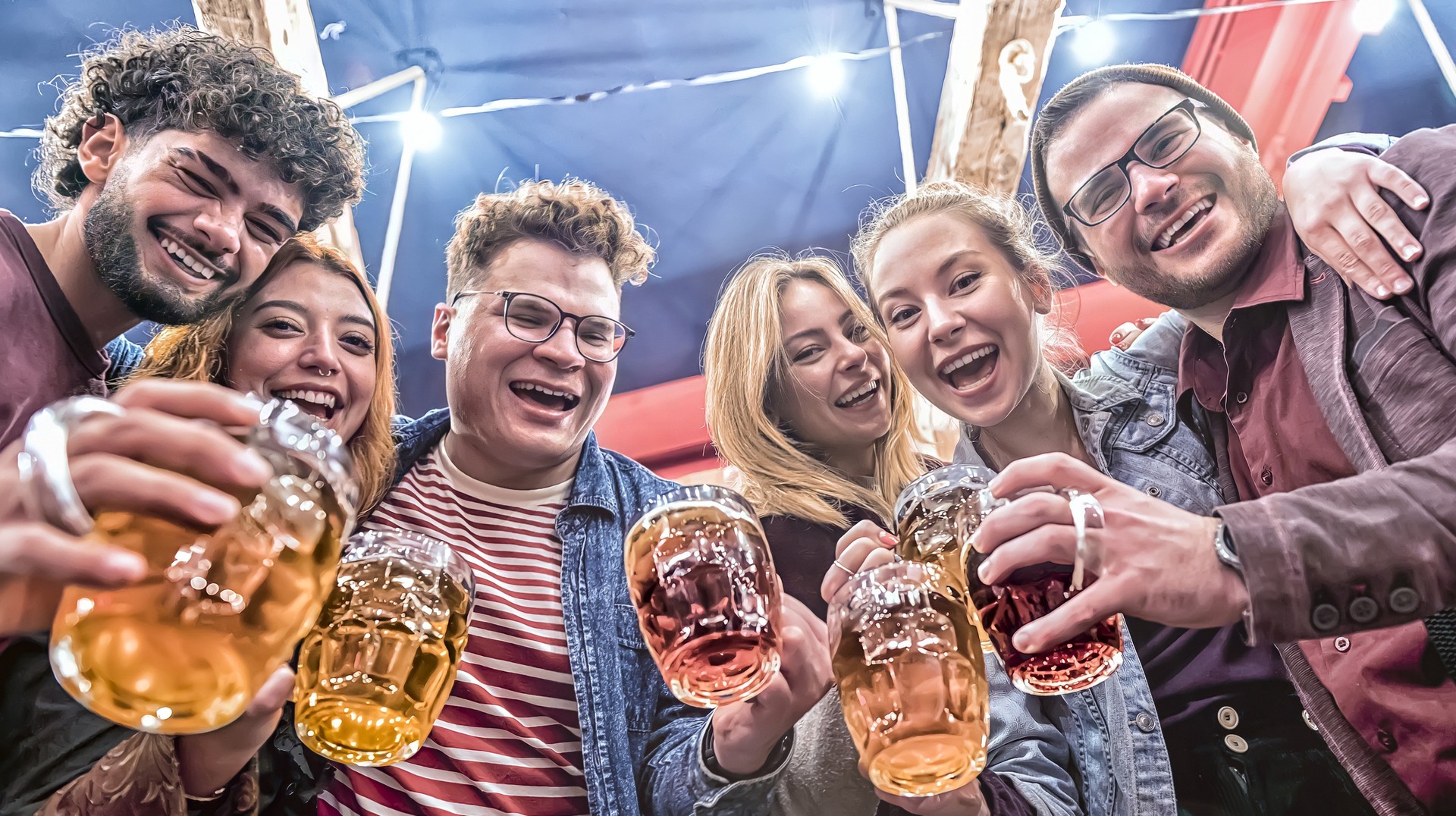 Celebrate with friends and enjoy the taste of traditional german beers at the world-famous Oktoberfest Beer Festival in Germany in September. People enjoying beers during Oktoberfest Beer festival in Germany in September.