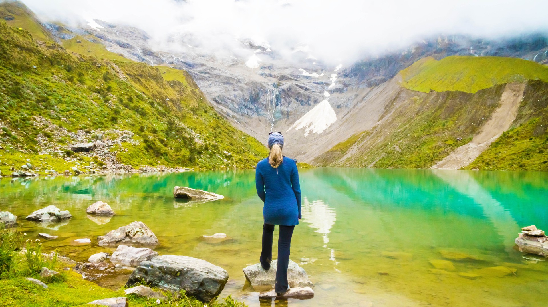 Peru is full of mountains and gorgeous trekking trails that are not as famous, but are equally impressive, as the Inca Trail A woman enjoying the scenery of Humantay Lake in Peru