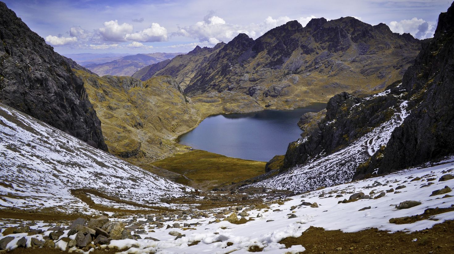 View of the lake and Lares Valley from the top of the mountain pass